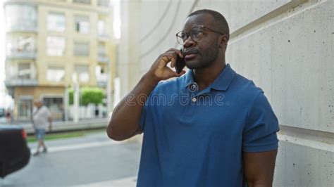 Handsome Young Man on Urban Street Talks on Smartphone while Standing ...