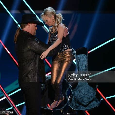 Hosts Trace Adkins And Kristin Chenoweth Speak Onstage During The