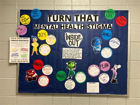 A Bulletin Board With Various Stickers On It In Front Of A White Brick