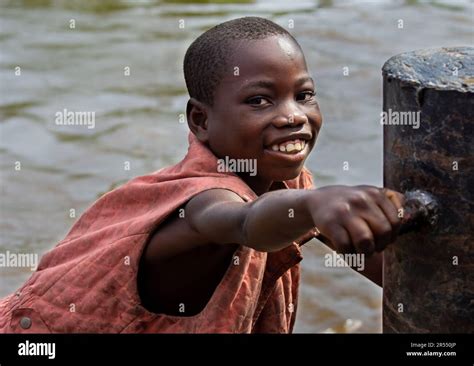 Congolese Boy Selling Fruit To A Passing Barge Democratic Republic Of