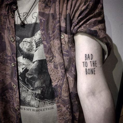 "Bad to the bone" tattoo on the left bicep.