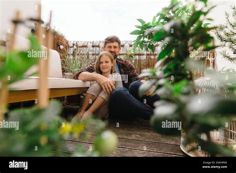Smiling Mature Man Sitting With Daughter In Balcony Stock Photo Alamy