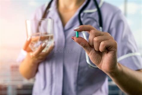 Cropped Photo Of Female Doctor Holding Pill And Glass Of Water In Two