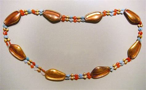 A Necklace Made Out Of Shells And Beads