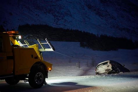 Premium Photo Car Being Towed After Accident In Snow Storm In