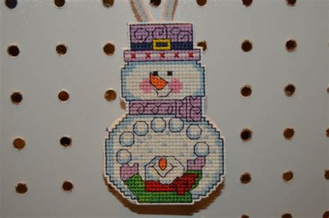 completed cross stitch snowman ornament