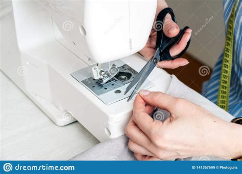 Close Up Partial View Of Seamstress Working With Sewing Machine At