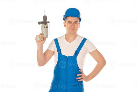 young man builder with drill in hands 16505820 Stock Photo at Vecteezy