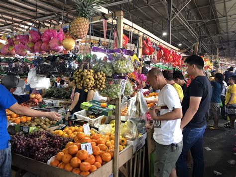 Filipinos buy round-shaped fruits at the Balintawak Market, believing these symbolize good luck ...