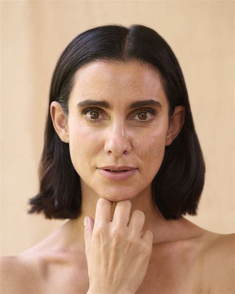 Beauty Portrait Of Smiling Mature Woman With Bare Shoulders Against Natural Background Stock
