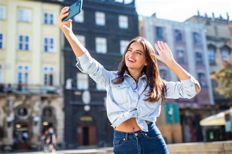 Young Woman Take Selfie From Hands With Phone On Summer City Street