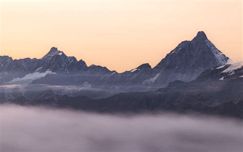 1680x1050 Mountain Range Covered In Fog Wallpaper1680x1050 Resolution