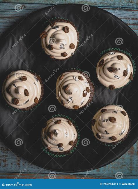 Top View Of Chocolate Cupcakes With Frosting And Coffee Beans In A