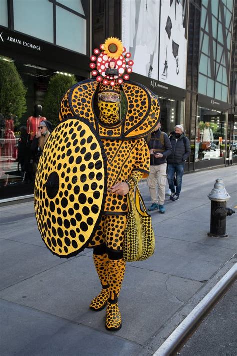 Man In Yellow And Black Costume In Easter Bonnet Parade Editorial