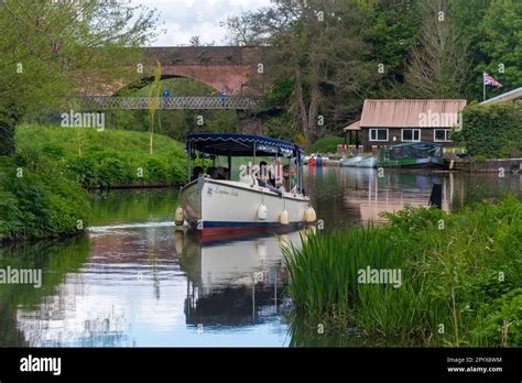 People Enjoying A Boat Trip On The River Wey At Dapdune Wharf On The