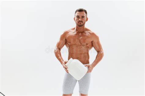 Man Bodybuilder Boxer With Naked Torso With Abs Holding A Can Of Muscle