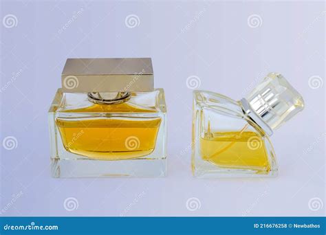 Women`s Perfume Bottles Half Filled With Golden Liquid Transparent