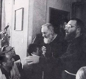 Black And White Photograph Of People Sitting In A Room