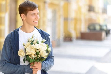 Handsome Guy Holding Flowers Stock Image Image Of Pleasant Foudness