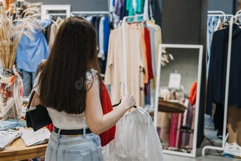 Second Hand Sustainable Fashion Young Latina Woman Buying Used Sustainable Clothes From Second