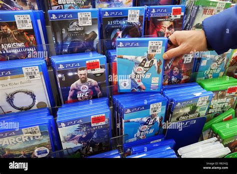 Store Display Filled With Playstation 4 Games For A Home Video Game