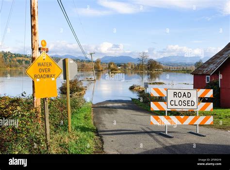 Multiple signs warning of flooding on country road in the Snoqualmie ...