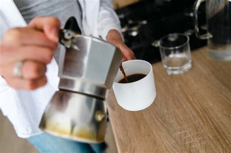 Premium Photo A Person Pouring Coffee Into A Cup