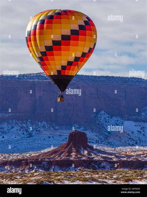 A Hot Air Balloon Flying Over The Hub In The Monument Valley Balloon