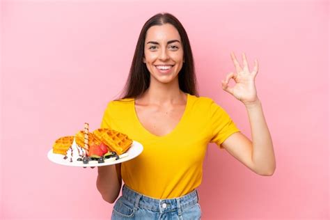 Jovem Mulher Caucasiana Segurando Waffles Isolados Em Fundo Rosa