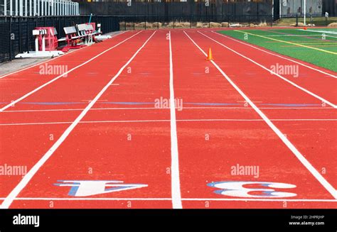 Looking Doewn A Red Track With Blue Outlines From The Finish Line To