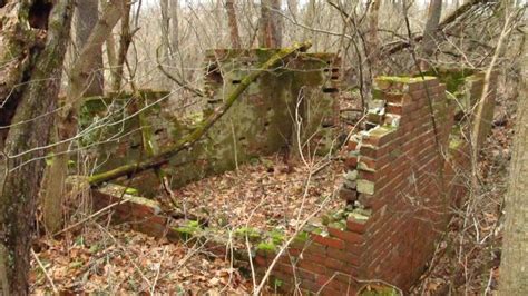 An Old Brick Structure In The Woods Surrounded By Trees And Leaves With