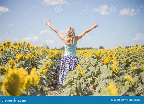 Beauty Sunlit Woman On Yellow Sunflower Field Freedom And Happiness