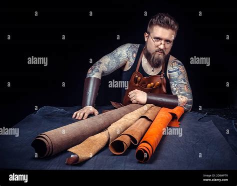 Leather cutter demostrating leather cutting process Stock Photo - Alamy