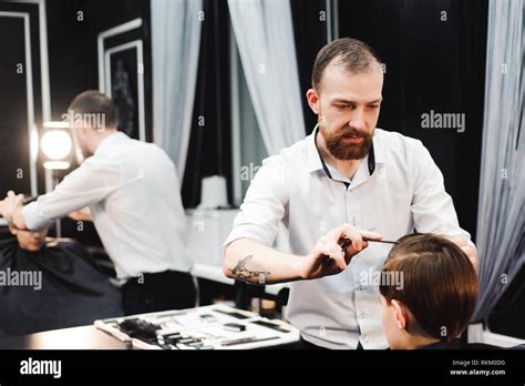 cute young boy getting a haircut in a salon Stock Photo - Alamy