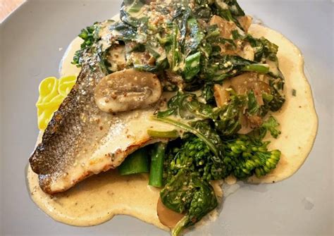 Pan Fried Sea Bass With Wholegrain Mustard Mushroom And Spinach Sauce Finished With Wild Garlic