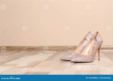 Pair Of High Heeled Shoes On Floor Near Color Wall Stock Photo Image