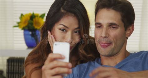 Happy Interracial Couple Dating On A Beach And Take A Selfie Video Or