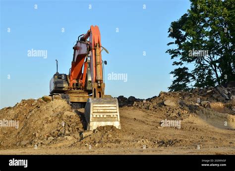 Excavator At A Construction Site During Earthworks And Laying Of