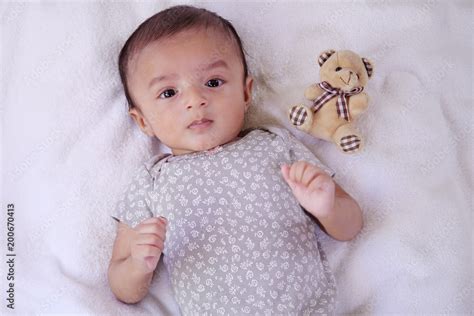 Newborn baby boy with teddy bear on bed Stock Photo | Adobe Stock