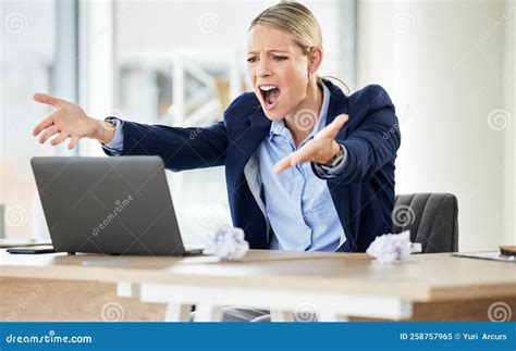 A Young Caucasian Businesswoman Yelling While Using A Laptop In An