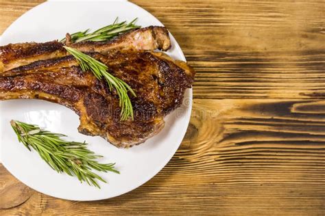 Filete De Costilla De Ternera Asada En Hueso Con Romero En Plato Blanco