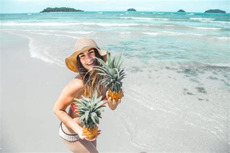 Beautiful Girl With Pineapple On An Exotic Beach A Happy Mood A Stock