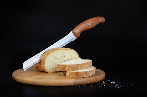 Premium Photo Knife Slicing Freshly Baked Loaf Of Bread