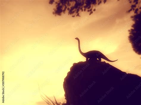 Stunning Silhouette At Sunset Of The Diplodocus Dinosaur With Its Typical Sauropod Shape Long