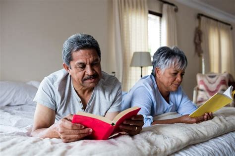 Premium Photo Senior Couple Reading Books On Bed