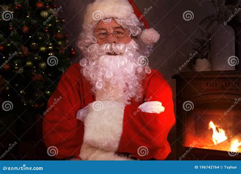 Traditional Santa Claus Standing by the Fireplace and Christmas Tree in ...