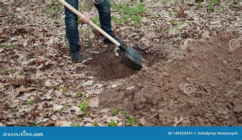 A Businessman Digging And Mining To Find Treasure Close Up Stock