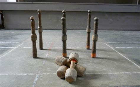 Several Wine Corks Sitting On The Ground In Front Of Some Poles That