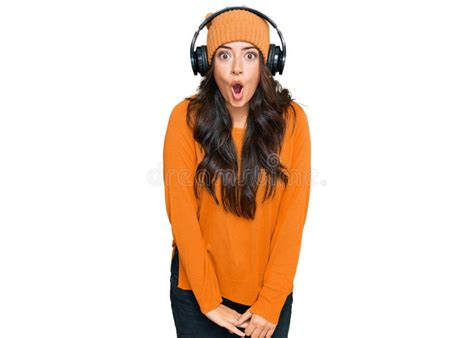 Beautiful Brunette Young Woman Listening To Music Using Headphones