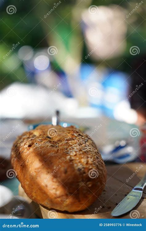 Selective Shot Of A French Loaf Bread On A Wooden Cutting Board Stock